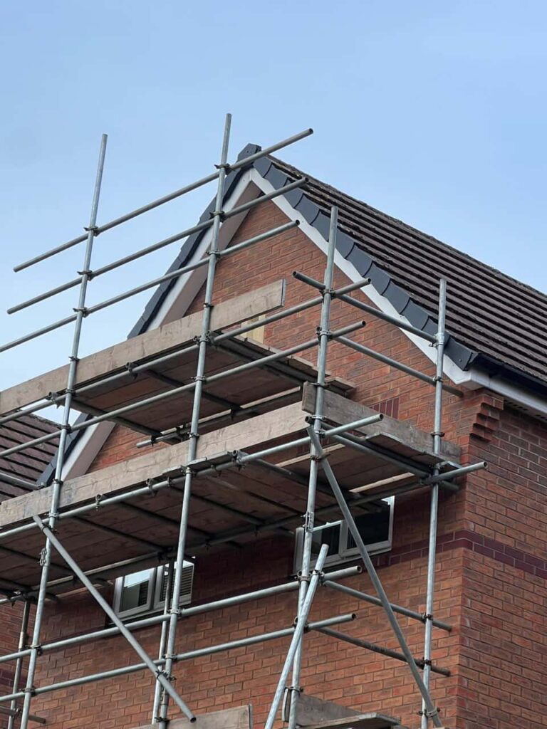 This is a photo of a roof which has just been repaired. There is a scaffold located at the gable end for access onto the roof. Works carried out by East Grinstead Roofing Repairs